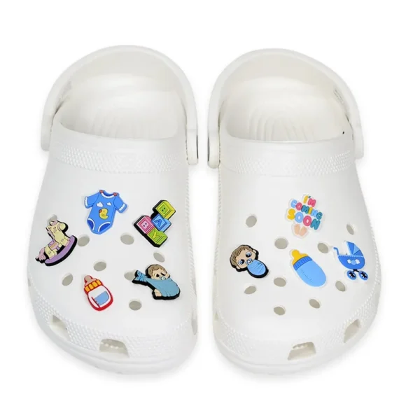 White Crocs with adorable newborn Baby Boy Shoe Charms, including baby boy and girl designs, pacifier, bottle, stroller, onesie, baby footprints, and "I'm Coming Soon" charm.