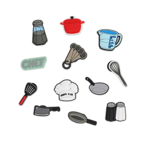 White footwear decorated with cooking-themed charms, including a chef's hat, frying pan, salt & pepper shakers, and kitchen utensils.