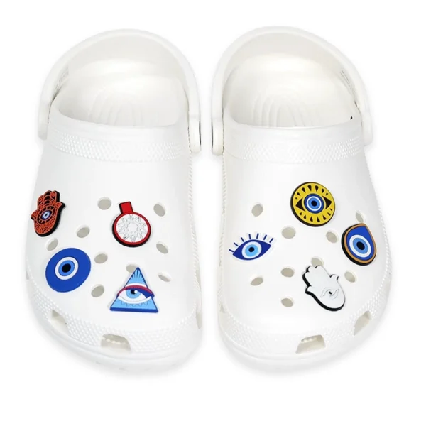 Shoe charms featuring Evil Eye, Hamsa hand, and mystical symbols on white slip-on sandals