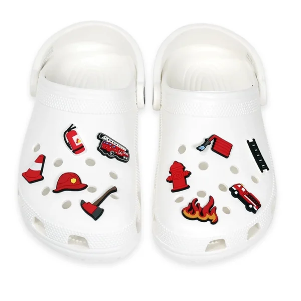 White footwear decorated with Firefighter Shoe Charms, including a fire truck, fire hydrant, fire helmet, axe, flames, and ladder