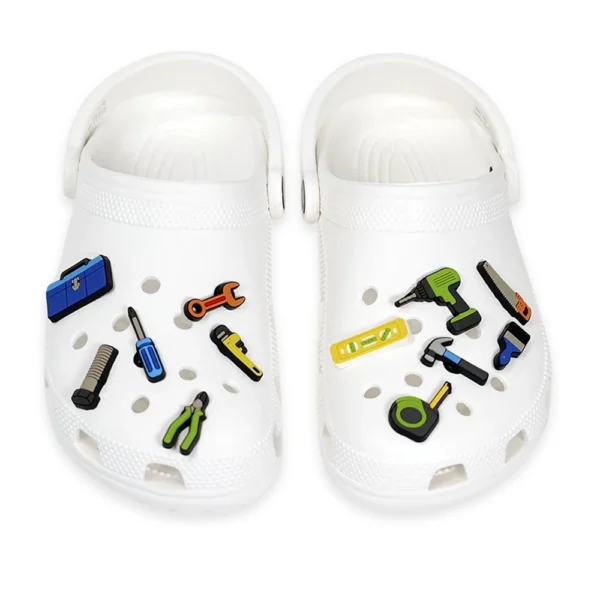 Construction and tool-themed shoe charms, including wrenches, drills, screwdrivers, and measuring tape.