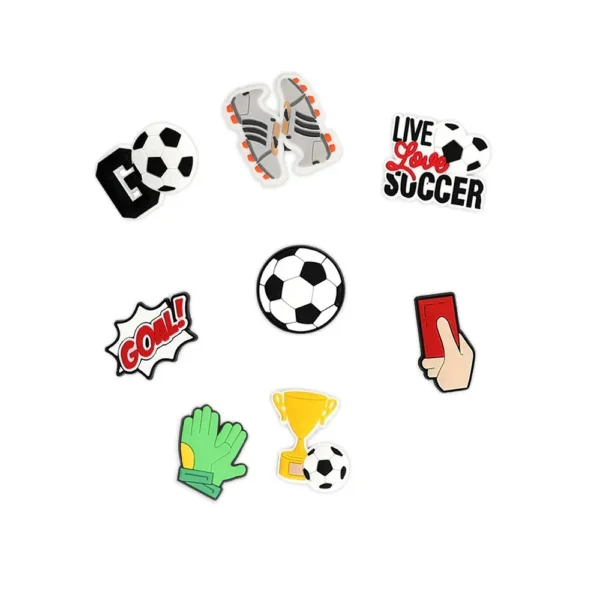 White footwear decorated with soccer-themed charms, including a red card, goal celebration sign, trophy, soccer ball, and "Live Love Soccer" text.