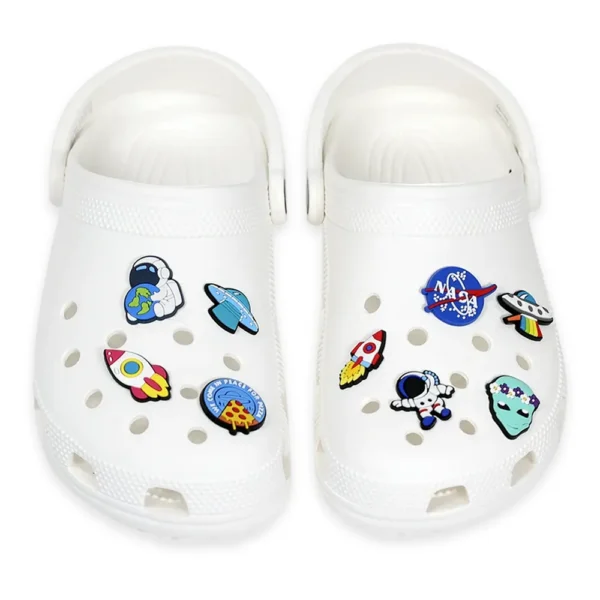 White Clog Sandals decorated with Space Shoe Charms, featuring astronauts, rockets, planets, and UFO designs.