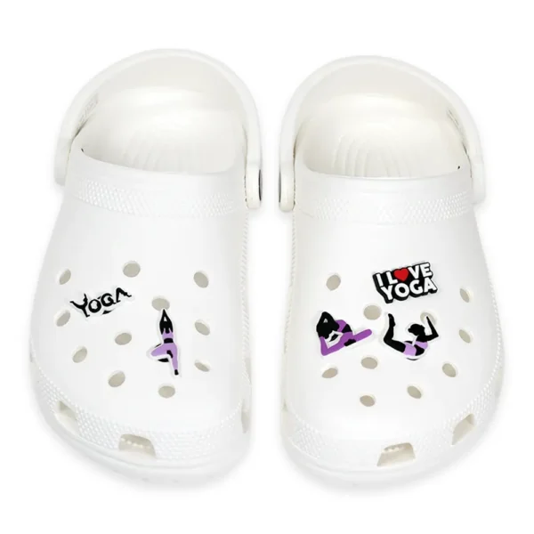 White footwear decorated with yoga-themed charms, including yoga poses, "I Love Yoga" text, and meditation symbols.