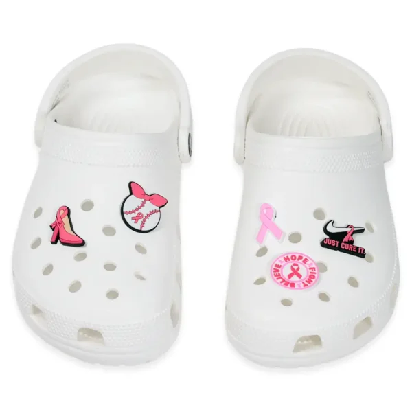 Breast cancer awareness charms on white Crocs – pink ribbon and words of hope as purposeful decoration