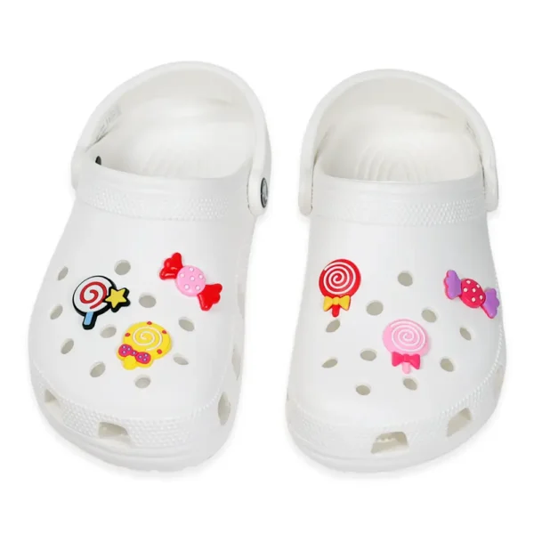 Candy Charms for Crocs Bundle - White Crocs decorated with candy-themed shoe charms including colorful lollipops and wrapped sweets.