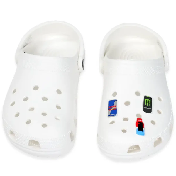 White footwear decorated with Energy Drink Shoe Charms for Crocs – Red Bull, Prime bottle, and Monster-inspired charms