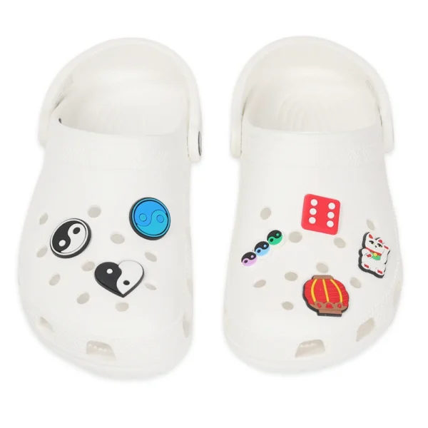 Feng Shui shoe charms placed on white clogs